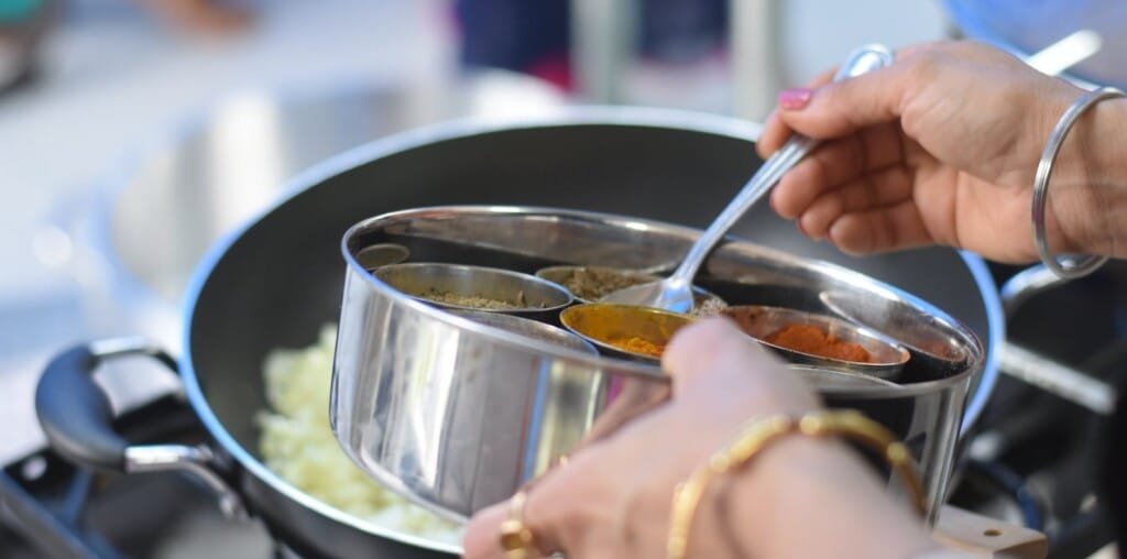 a woman cooking indian food